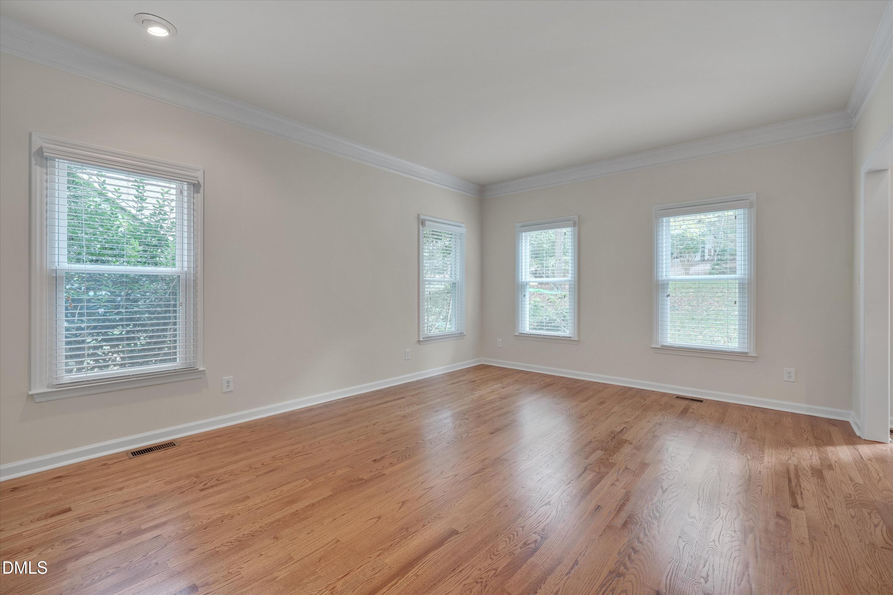 205 Cates Farm Road Chapel Hill, NC 27516 - Photo 9 of 56 a view of an empty room with wooden floor and a window