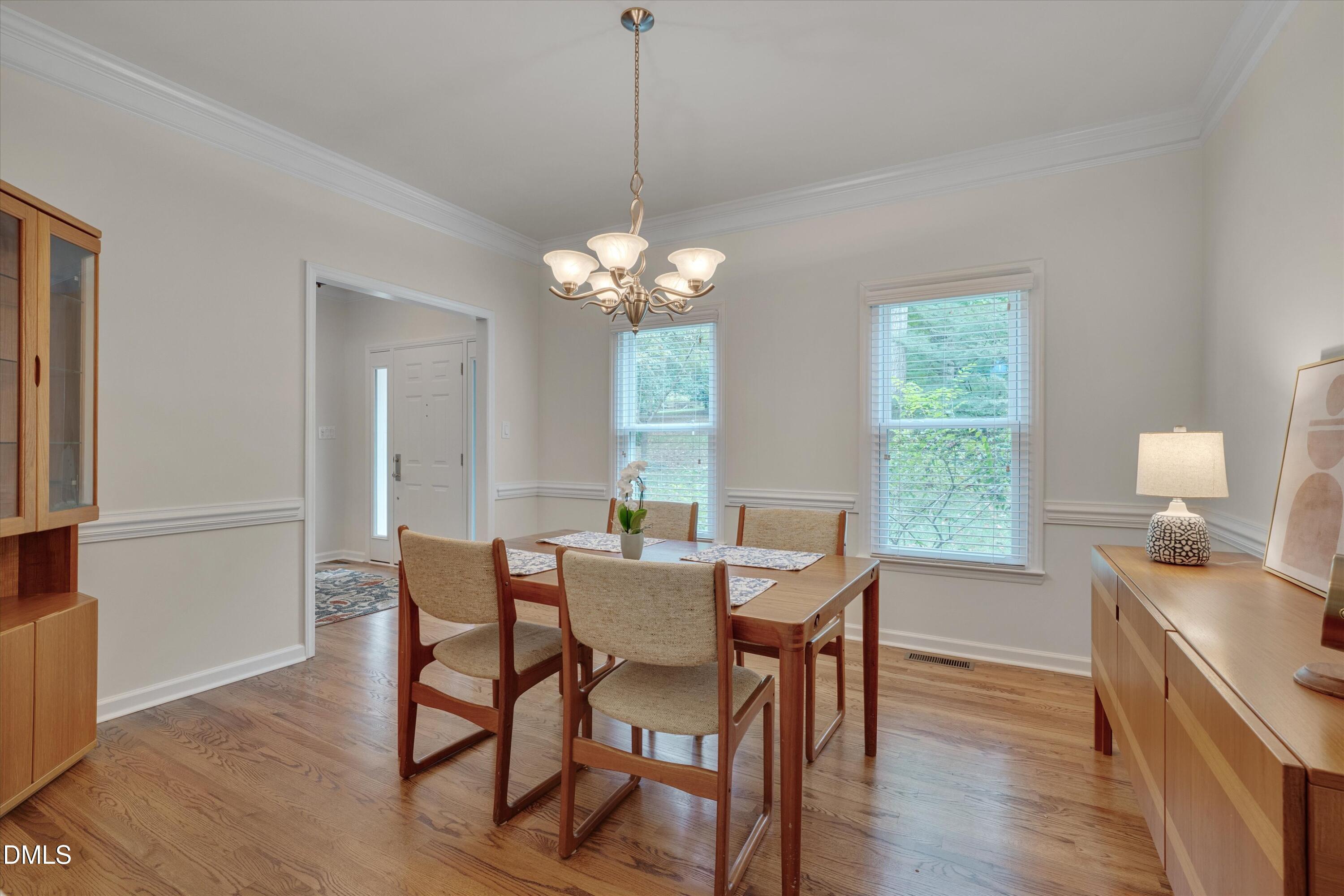 205 Cates Farm Road Chapel Hill, NC 27516 - Photo 10 of 56 a dining room with furniture a chandelier and wooden floor