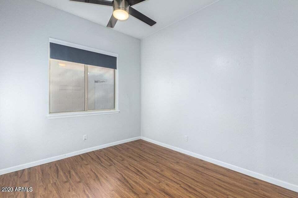 7514 East Wingspan Way Scottsdale, AZ 85255 - Photo 13 of 18 an empty room with a window and wooden floor