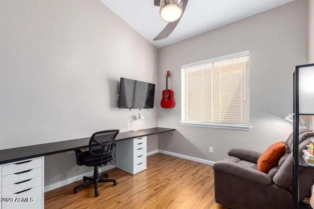 a livingroom with workspace and a window