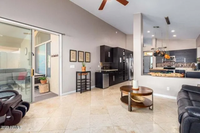 a kitchen with stainless steel appliances kitchen island granite countertop a refrigerator and a sink