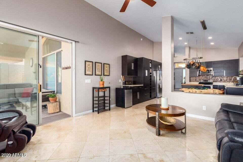 7514 East Wingspan Way Scottsdale, AZ 85255 - Photo 8 of 18 a kitchen with stainless steel appliances kitchen island granite countertop a refrigerator and a sink