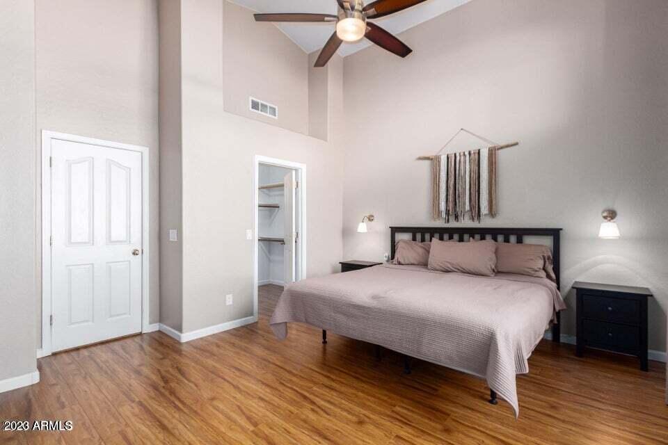 7514 East Wingspan Way Scottsdale, AZ 85255 - Photo 10 of 18 a bedroom with a bed and wooden floor