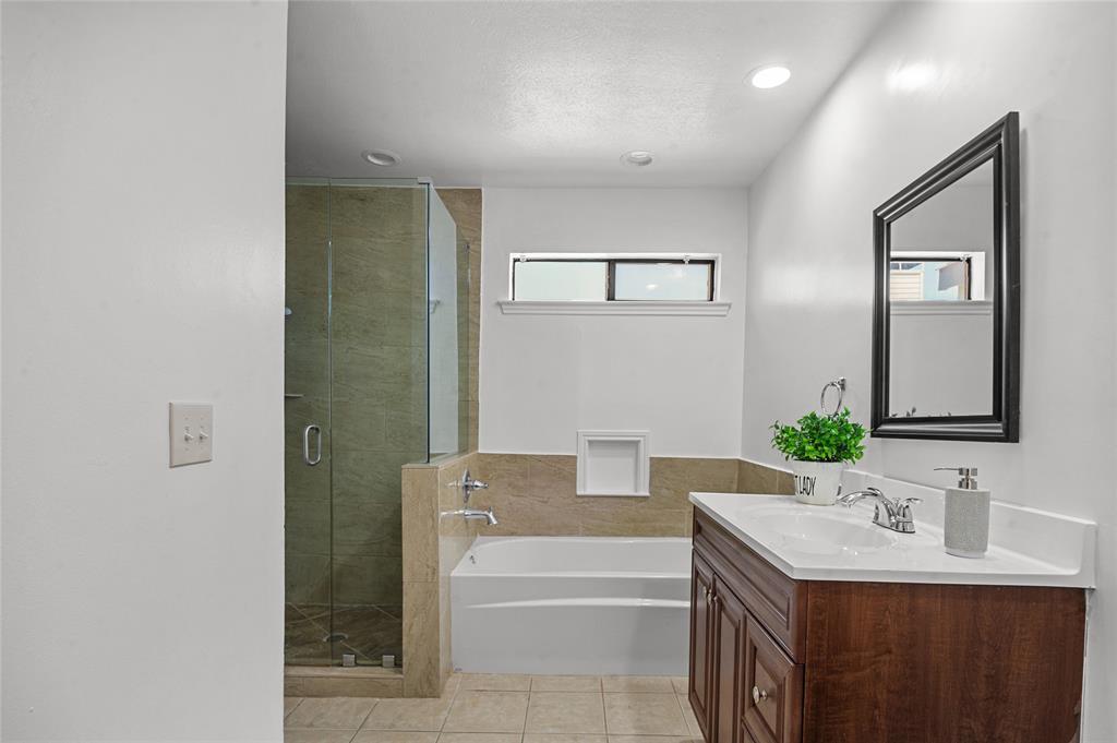 5100 Verde Valley Lane, Unit 245 Dallas, TX 75254 - Photo 16 of 24 a bathroom with a sink and a mirror