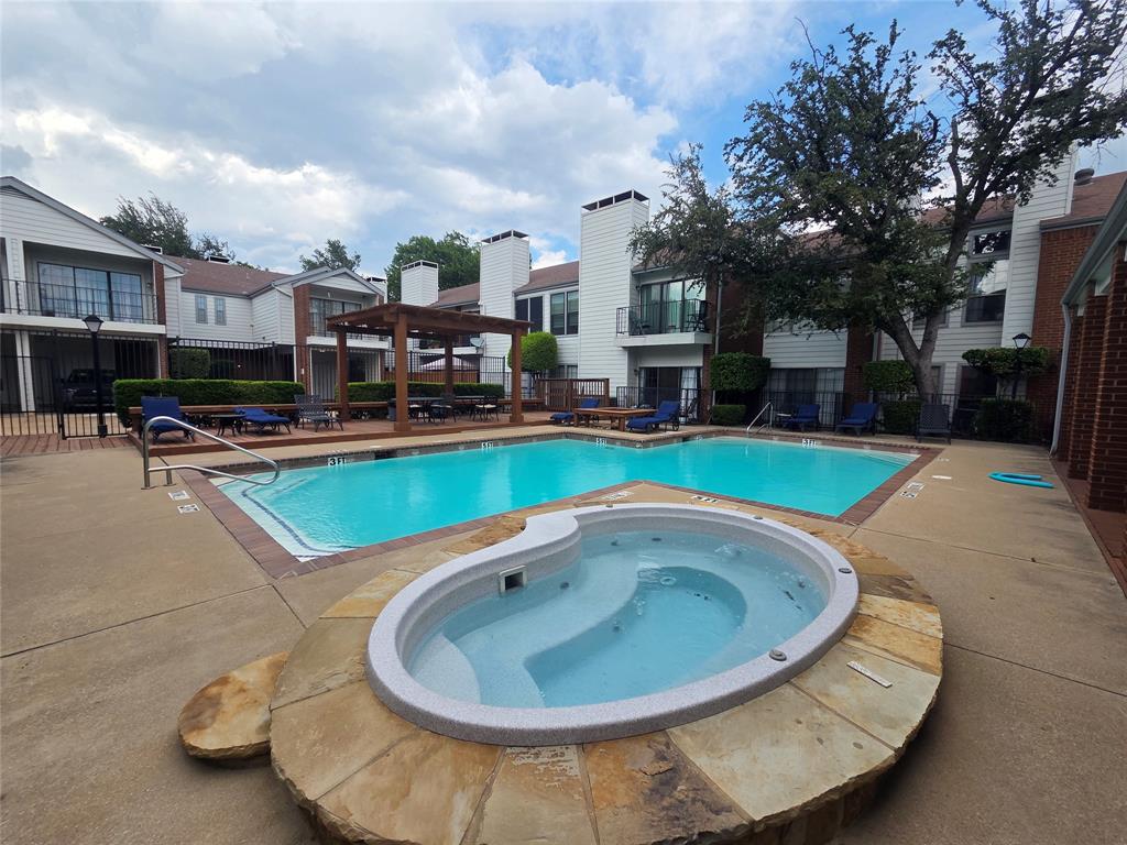 5100 Verde Valley Lane, Unit 245 Dallas, TX 75254 - Photo 21 of 24 a view of a swimming pool with a yard and plants