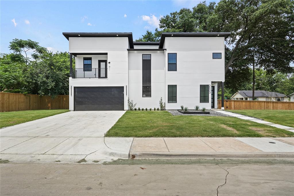 2603 Tanner Street Dallas, TX 75215 - Photo 1 of 1 Modern home with a balcony, a garage, stucco siding, and concrete driveway