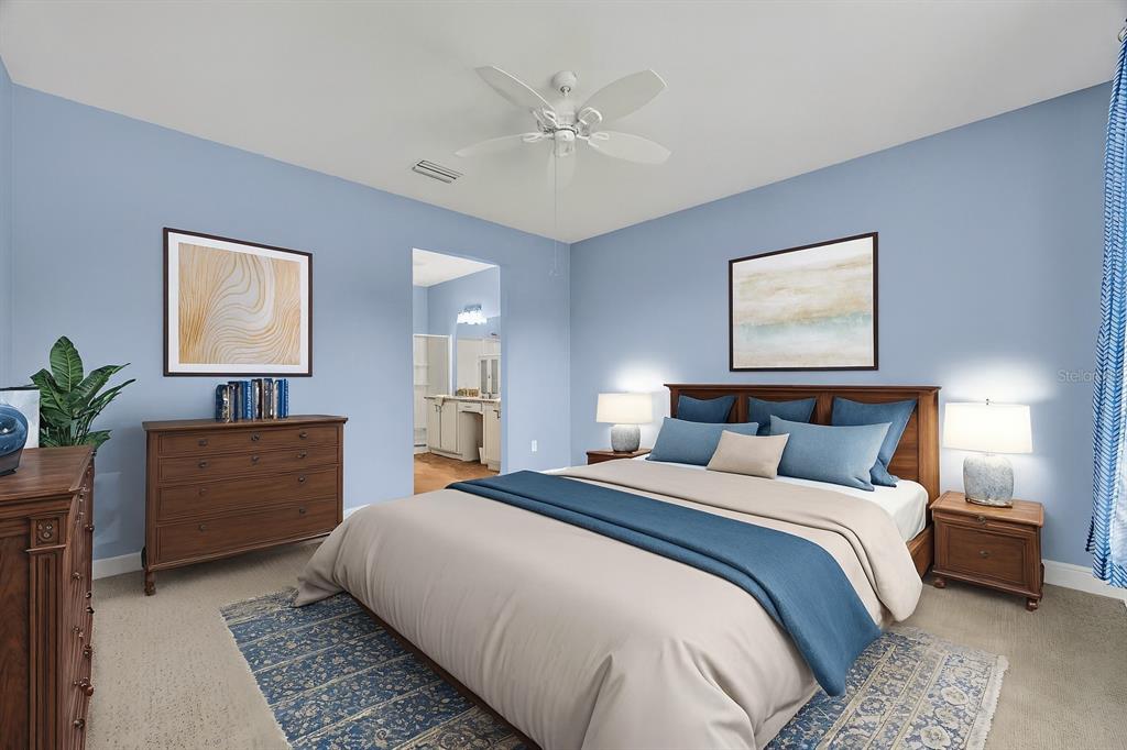 134 Silver Maple Road Groveland, FL 34736 - Photo 26 of 73 a bedroom with a large bed and a chandelier