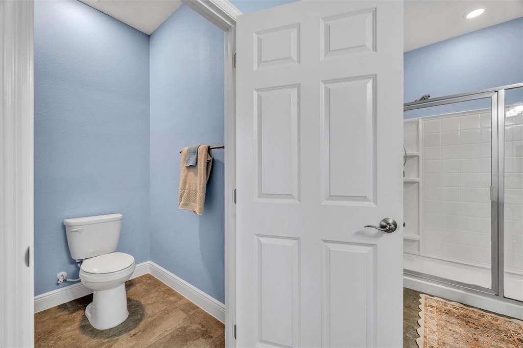 134 Silver Maple Road Groveland, FL 34736 - Photo 29 of 73 a white toilet sitting next to a bathroom sink