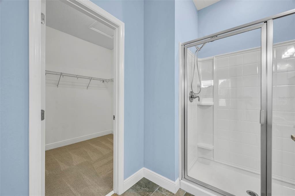 134 Silver Maple Road Groveland, FL 34736 - Photo 30 of 73 a bathroom with a glass shower door