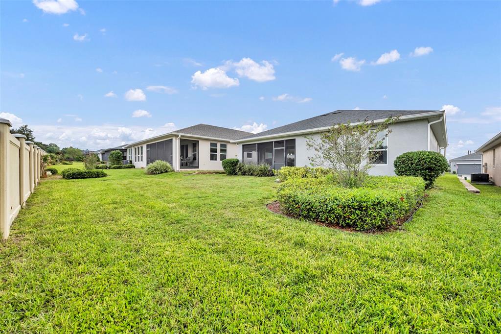 134 Silver Maple Road Groveland, FL 34736 - Photo 39 of 73 a view of a house with a big yard and potted plants