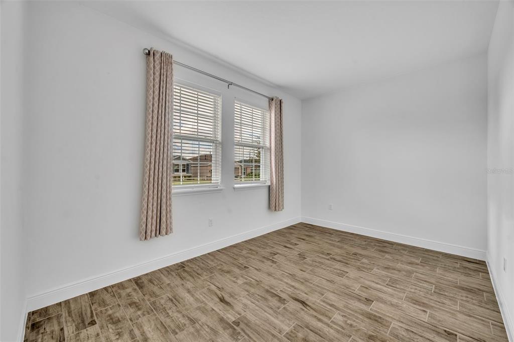 134 Silver Maple Road Groveland, FL 34736 - Photo 8 of 73 a view of an empty room with wooden floor and a window