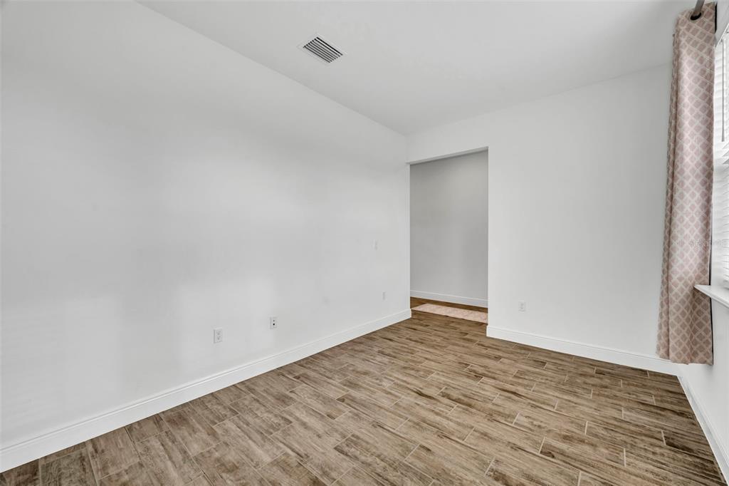134 Silver Maple Road Groveland, FL 34736 - Photo 10 of 73 a view of an empty room with wooden floor