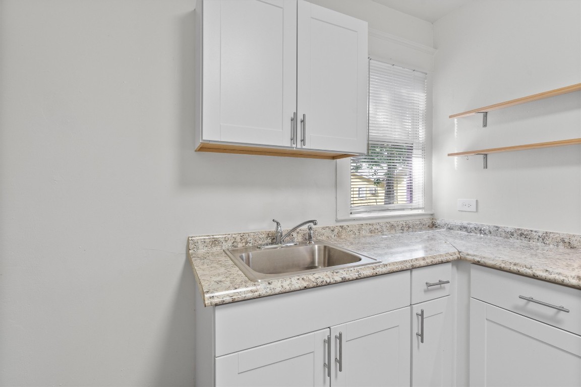 3404 Grooms Street, Unit B Austin, TX 78705 - Photo 7 of 11 Kitchen featuring a sink, white cabinets, and open shelves