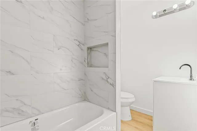 a bathroom with a bathtub and a toilet