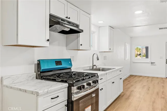 a white stove top oven sitting inside of a kitchen