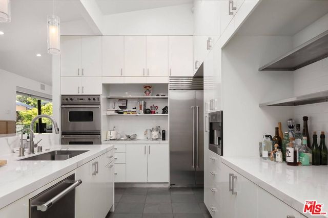 a kitchen with cabinets and stainless steel appliances