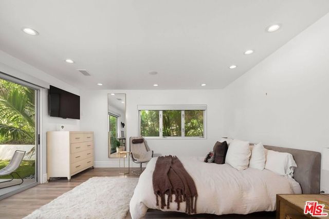 a bedroom with furniture and a flat screen tv