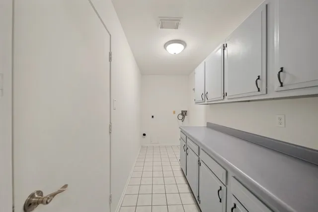 a view of a kitchen with white cabinets