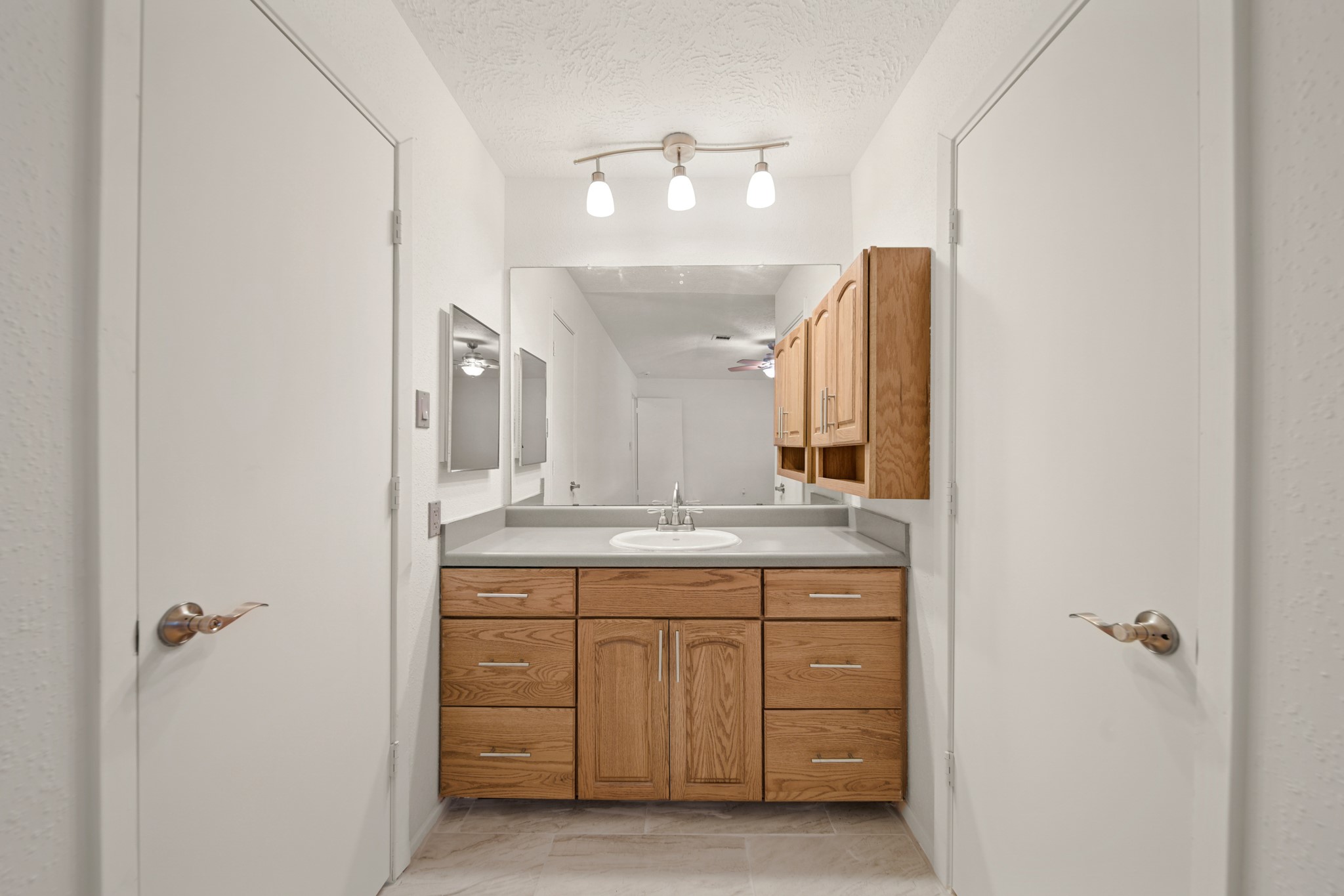 9903 Robin Street La Porte, TX 77571 - Photo 15 of 25 a bathroom with a granite countertop sink a mirror and a