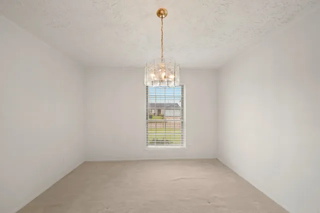 a view of a room with windows and chandelier