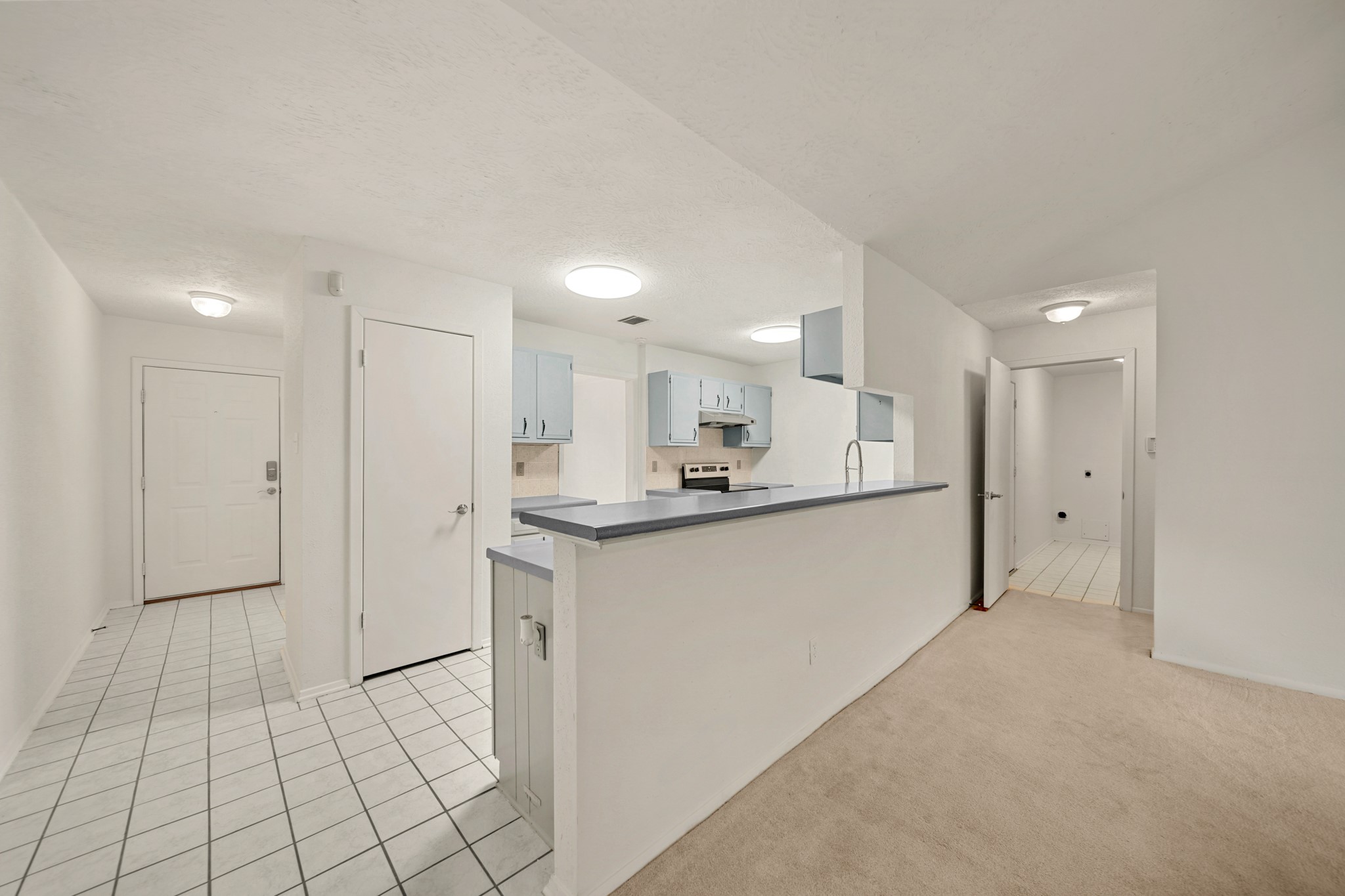 9903 Robin Street La Porte, TX 77571 - Photo 9 of 25 a large white kitchen with a sink and cabinets