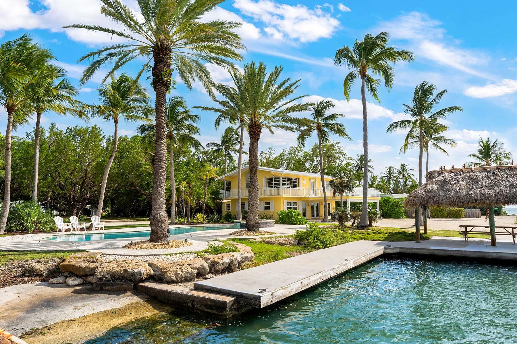 36 Sunset Road Key Largo, FL 33037 - Photo 21 of 55 a view of a swimming pool with a garden and trees
