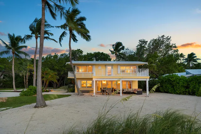 a living room with furniture a rug and a chandelier