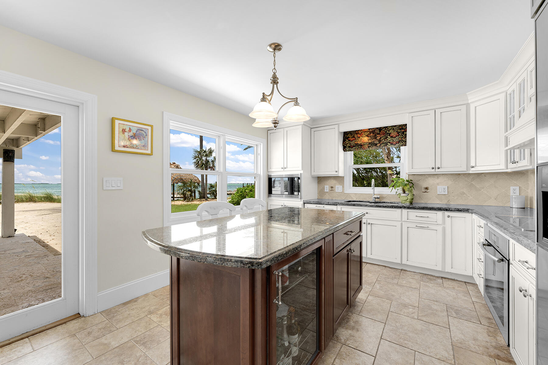 36 Sunset Road Key Largo, FL 33037 - Photo 34 of 55 a kitchen with center island table and chairs