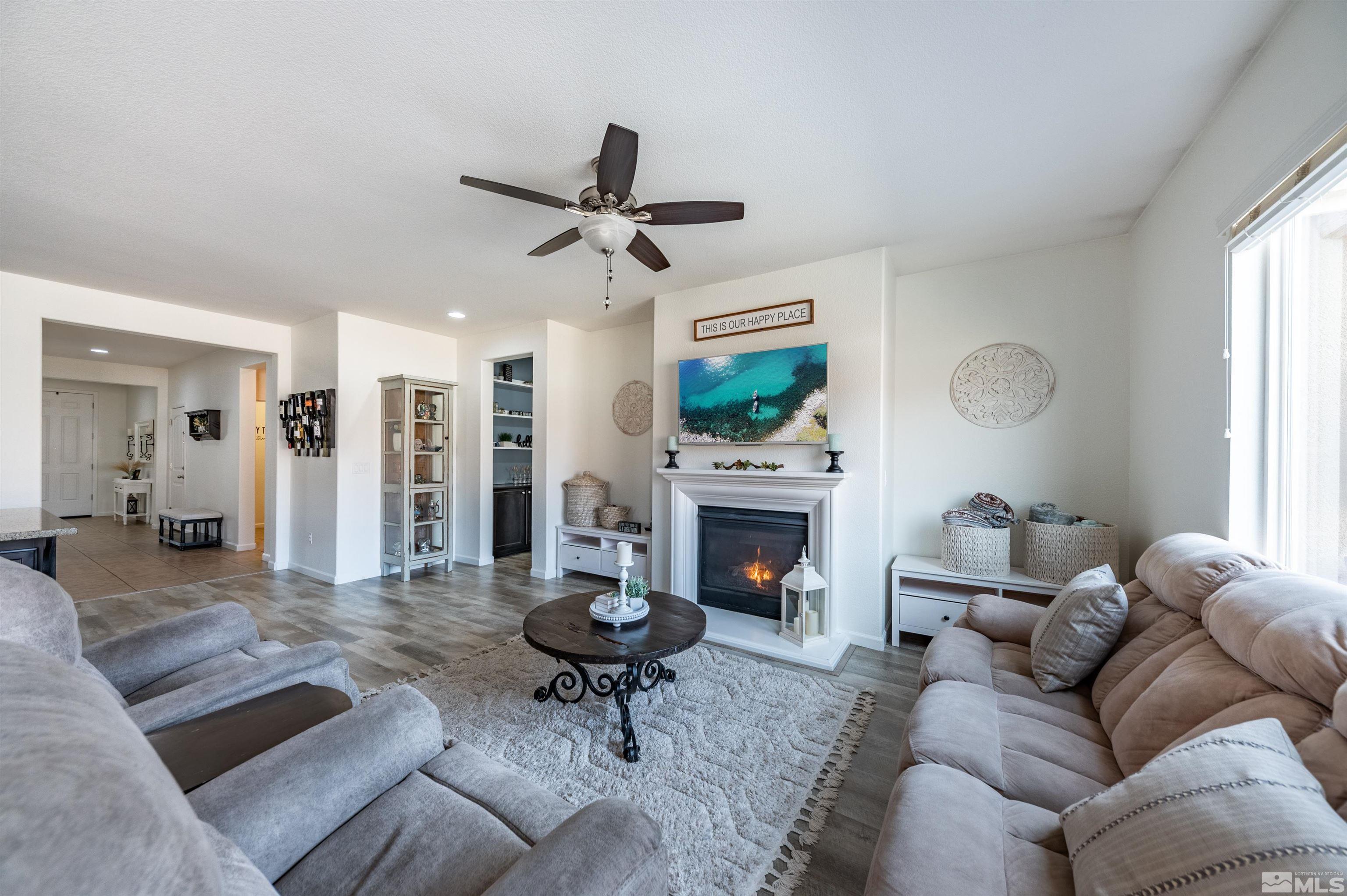 2045 Tawleed Road Reno, NV 89521 - Photo 13 of 33 a living room with furniture and a fireplace
