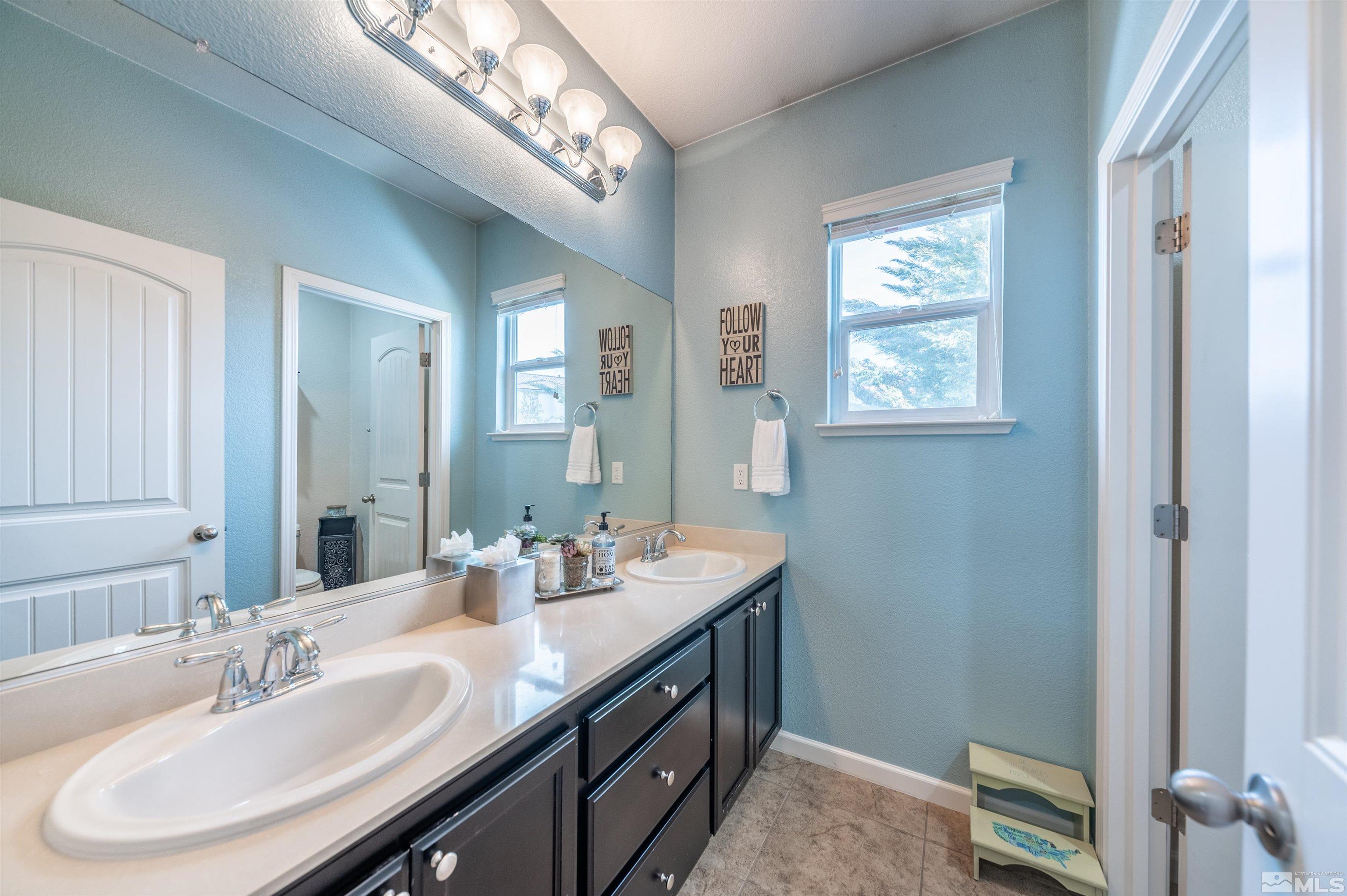 2045 Tawleed Road Reno, NV 89521 - Photo 23 of 33 a bathroom with a double vanity sink and a mirror