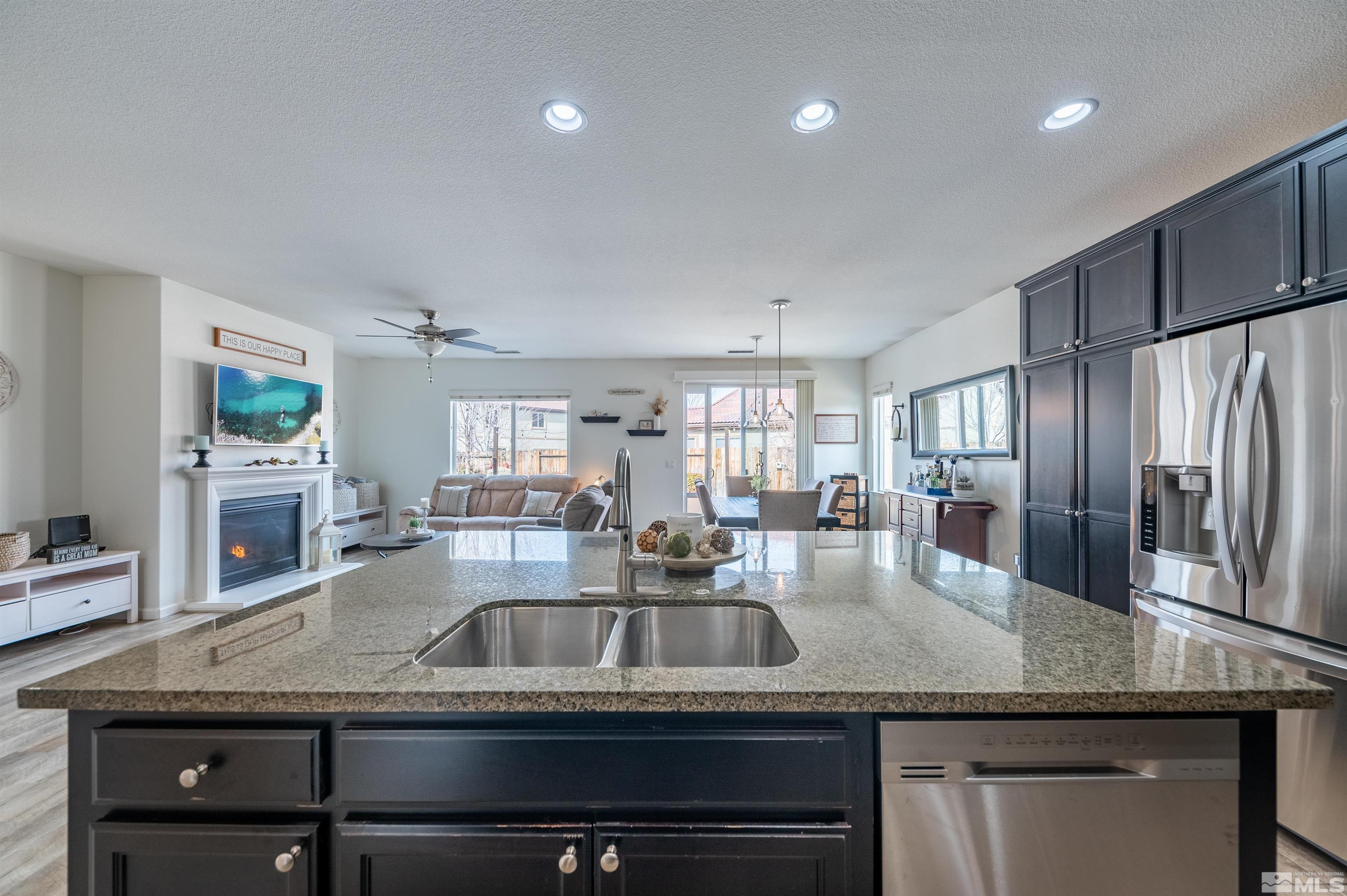 2045 Tawleed Road Reno, NV 89521 - Photo 5 of 33 a kitchen with granite countertop a sink stainless steel appliances and window