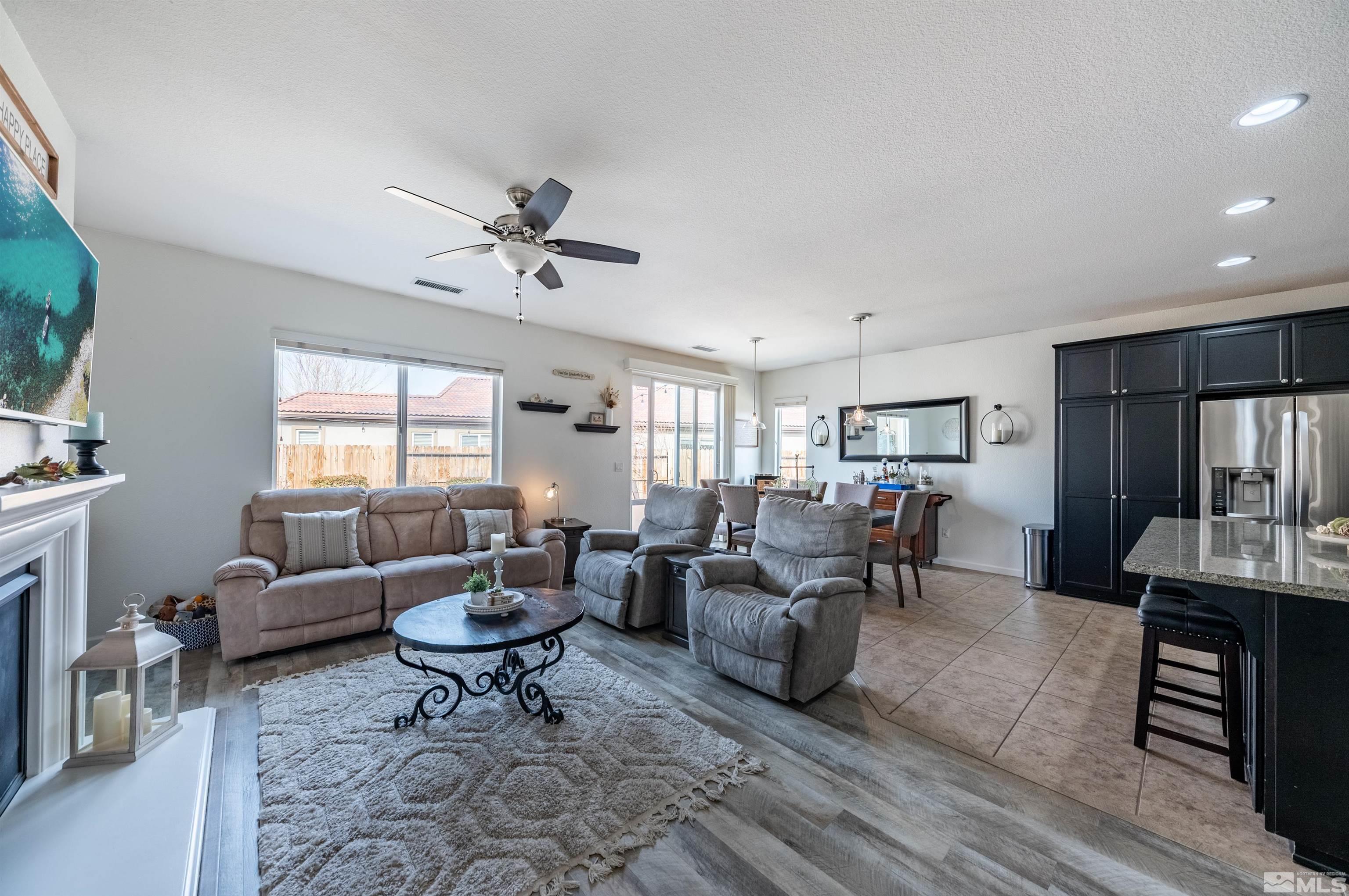 2045 Tawleed Road Reno, NV 89521 - Photo 10 of 33 a living room with furniture a fireplace and a large window