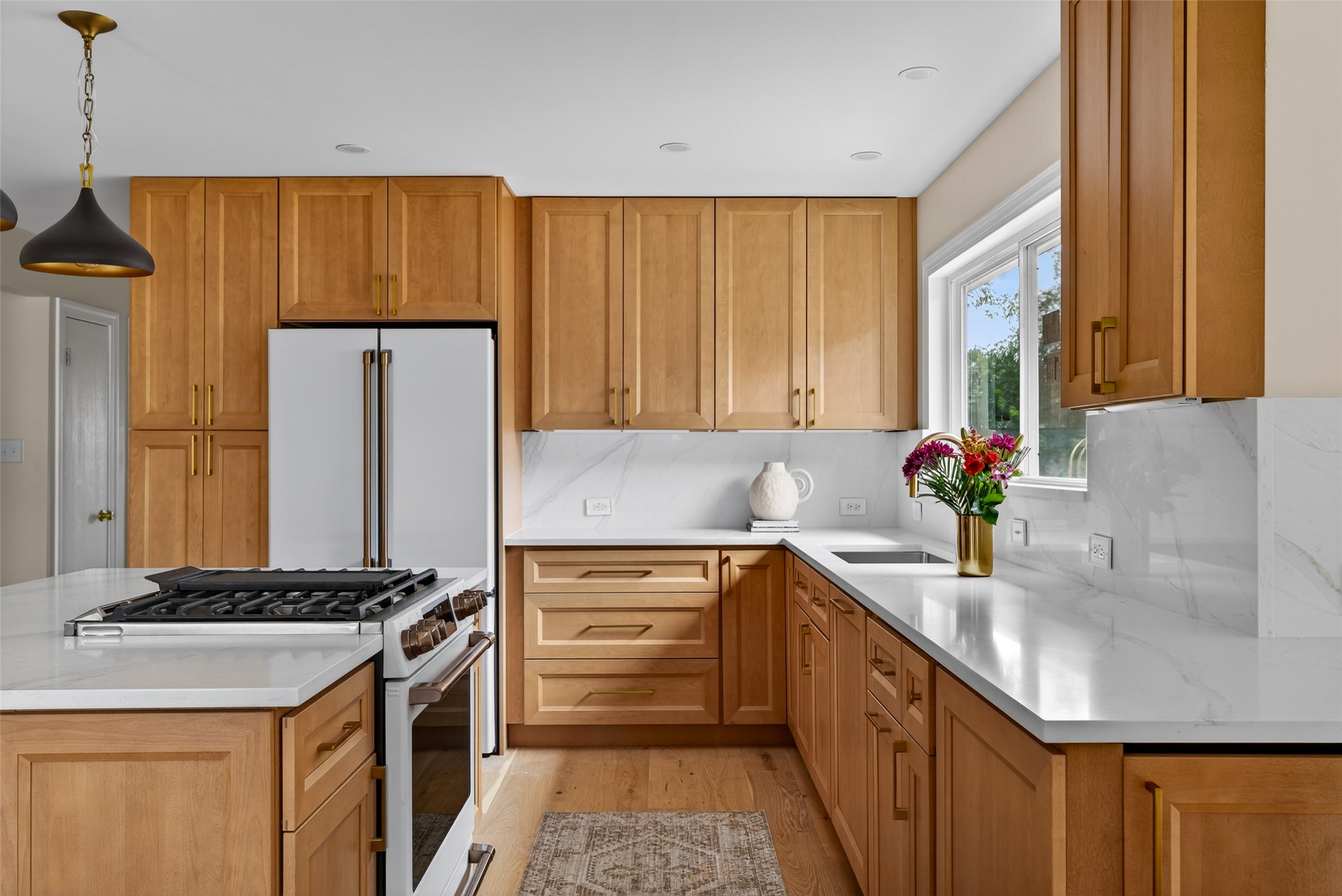 6806 Rearden Road Austin, TX 78745 - Photo 5 of 28 Kitchen featuring light wood cabinetry, white countertops, and a white refrigerator