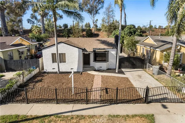 a view of a white house with large windows