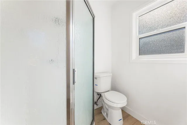 a white toilet sitting next to a bathroom sink