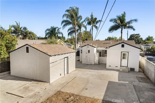 a white house with a tree in front of it
