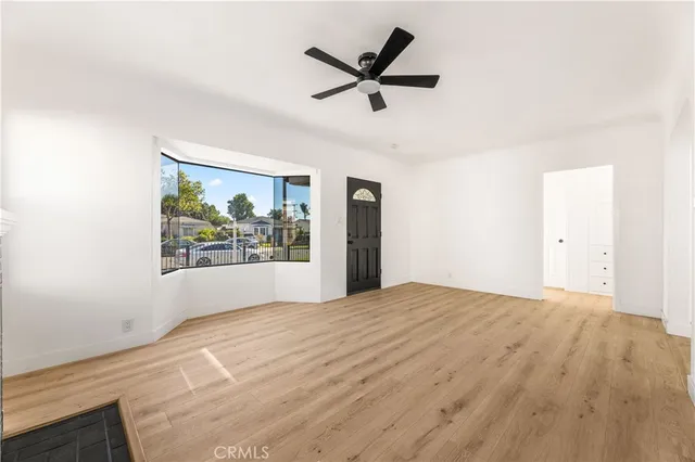 a view of a livingroom with a ceiling fan and window