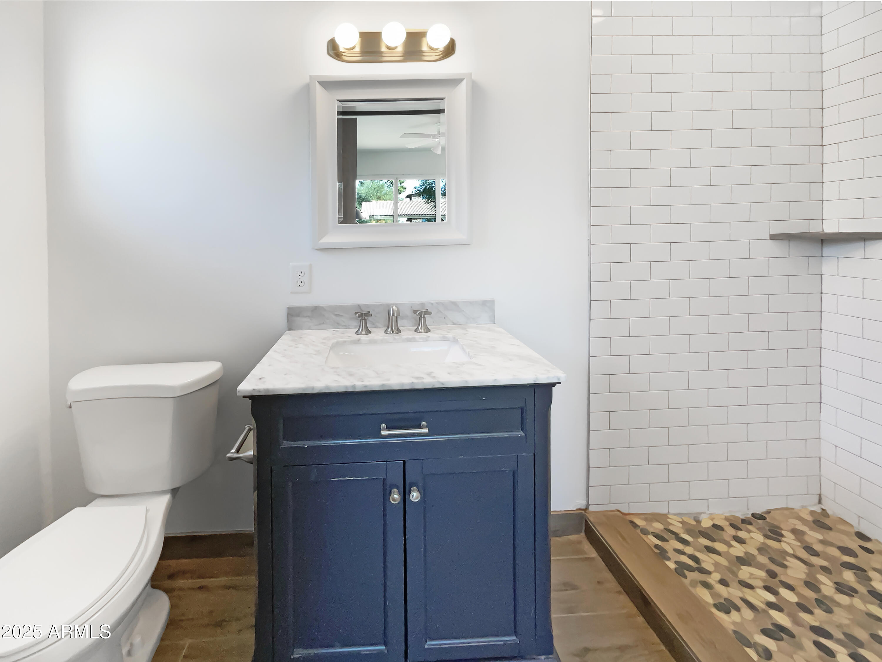7231 North 23rd Avenue Phoenix, AZ 85021 - Photo 19 of 28 a bathroom with a toilet a sink and mirror