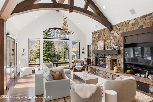 a living room with fireplace furniture and a large window