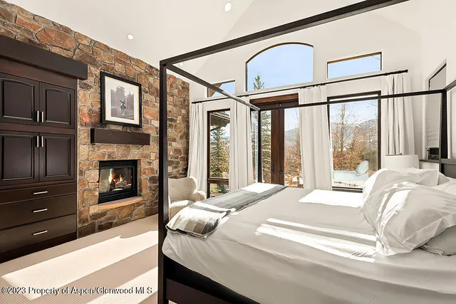 a bedroom with a bed next to a window