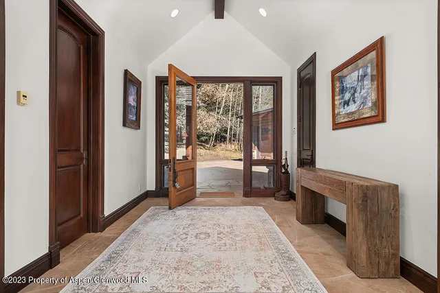 a view of a hallway with windows and closet