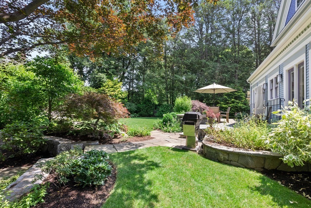 28 Monadnock Road Newton, MA 02467 - Photo 16 of 23 a view of a chair and table under an umbrella