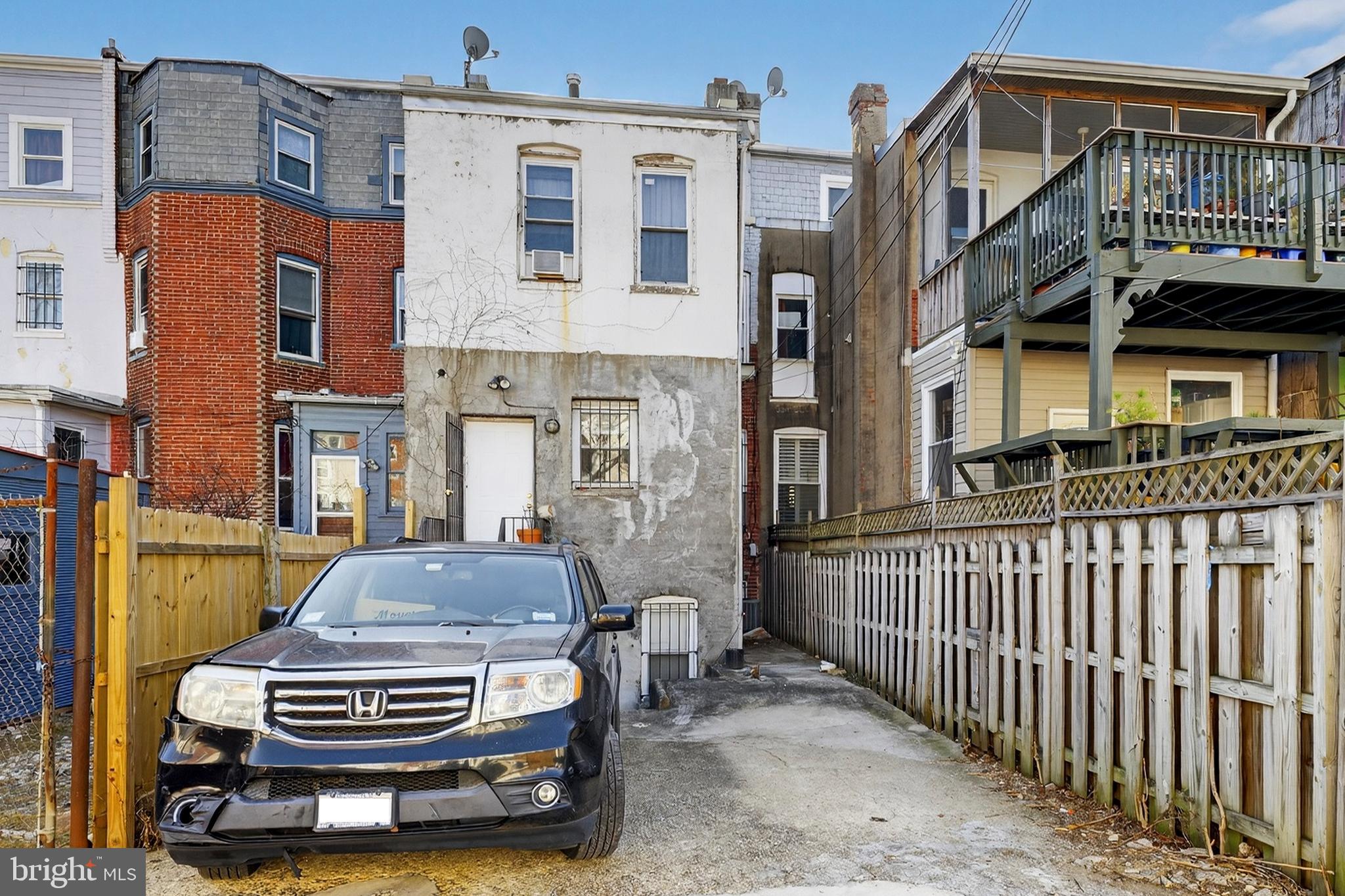 1351 Monroe Street Northwest Washington, DC 20010 - Photo 22 of 23 a car parked in front of a brick house
