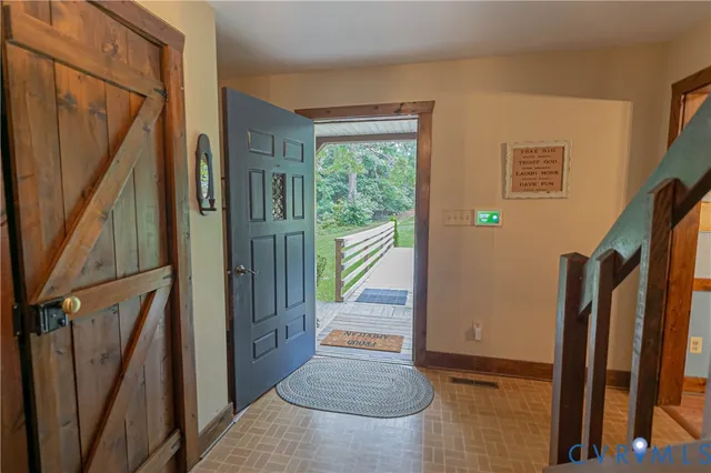 a view of entryway with wooden floor and stairs