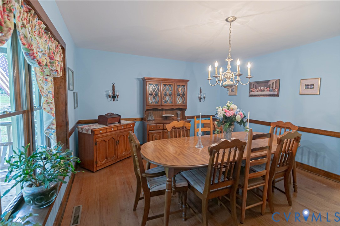 19321 River Road Chesterfield, VA 23838 - Photo 19 of 50 a view of a dining room with furniture a chandelier and wooden floor