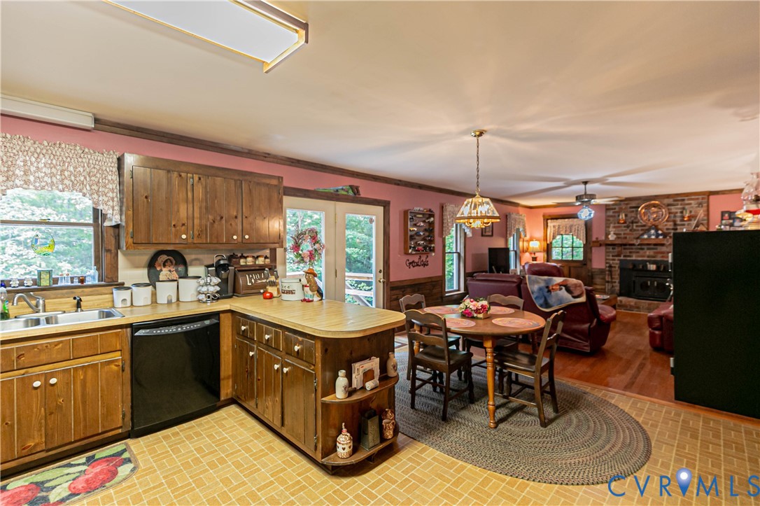 19321 River Road Chesterfield, VA 23838 - Photo 25 of 50 a kitchen with a stove a sink dishwasher a dining table and chairs with wooden floor