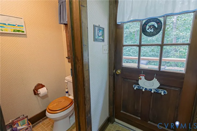 a bathroom with a toilet and a shower curtain