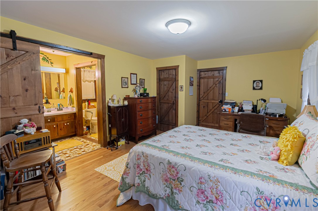 19321 River Road Chesterfield, VA 23838 - Photo 35 of 50 a bedroom with a bed and wooden floor