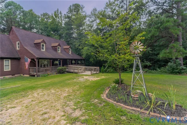 a view of a house with a backyard and a patio