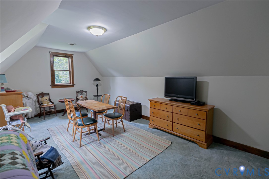 19321 River Road Chesterfield, VA 23838 - Photo 43 of 50 a living room with furniture a flat screen tv and kitchen view